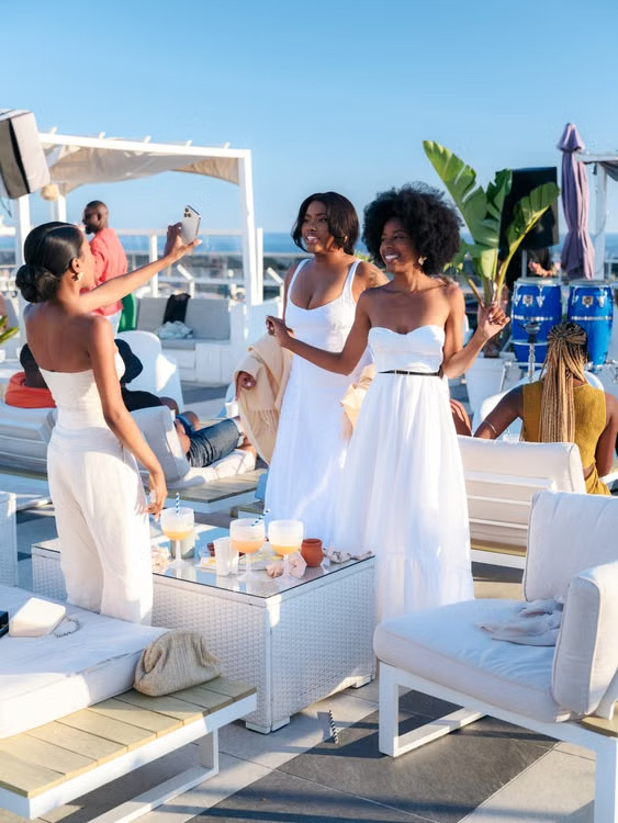 Black and Brown adults sharing an elegant social experience