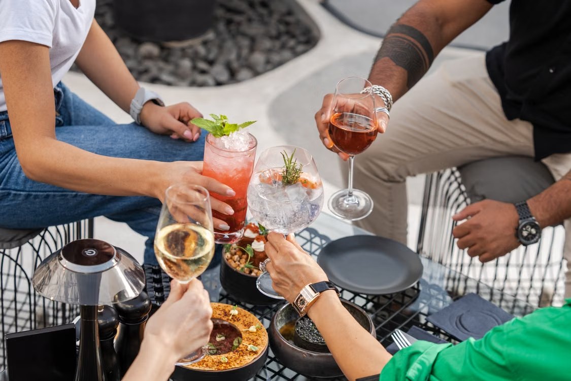 Friends raising a toast together around a table
