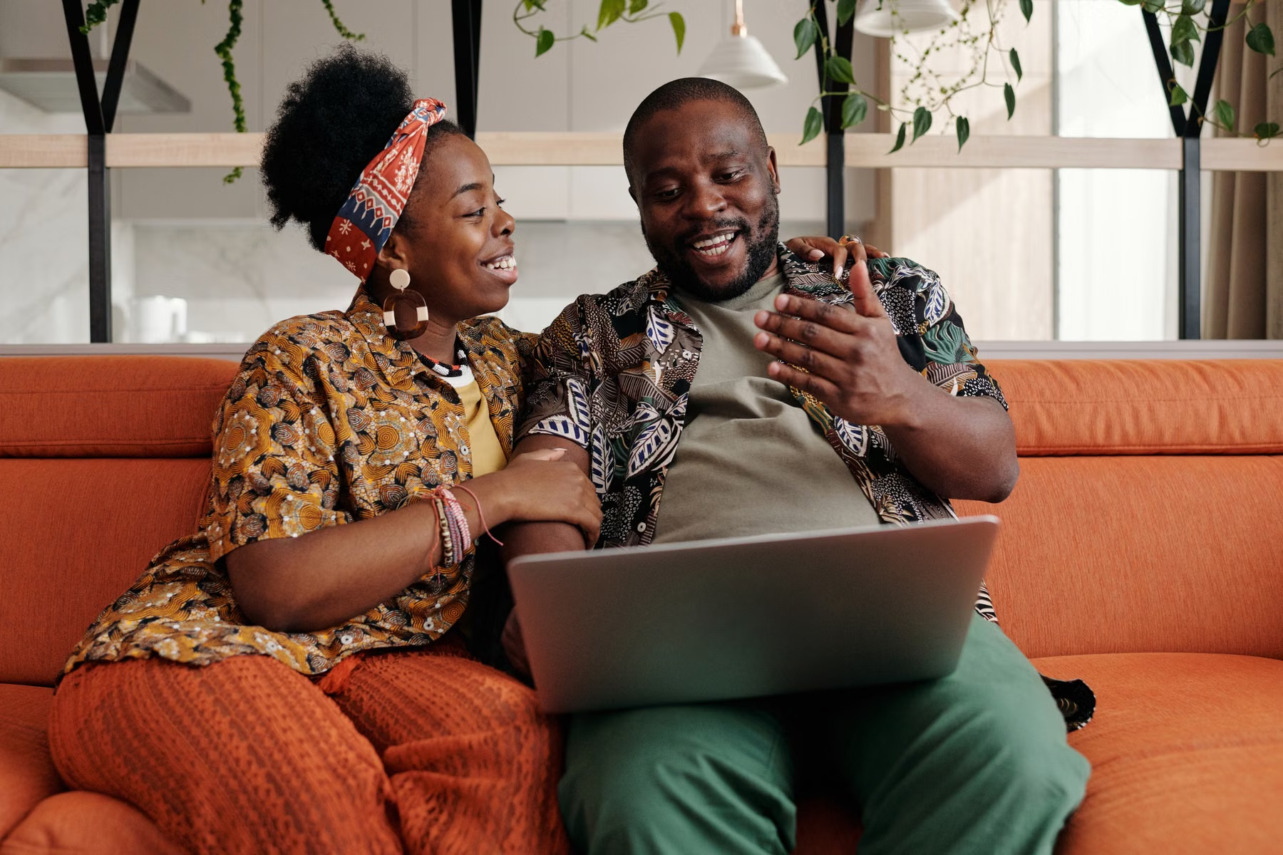 Black couple using a laptop together at home