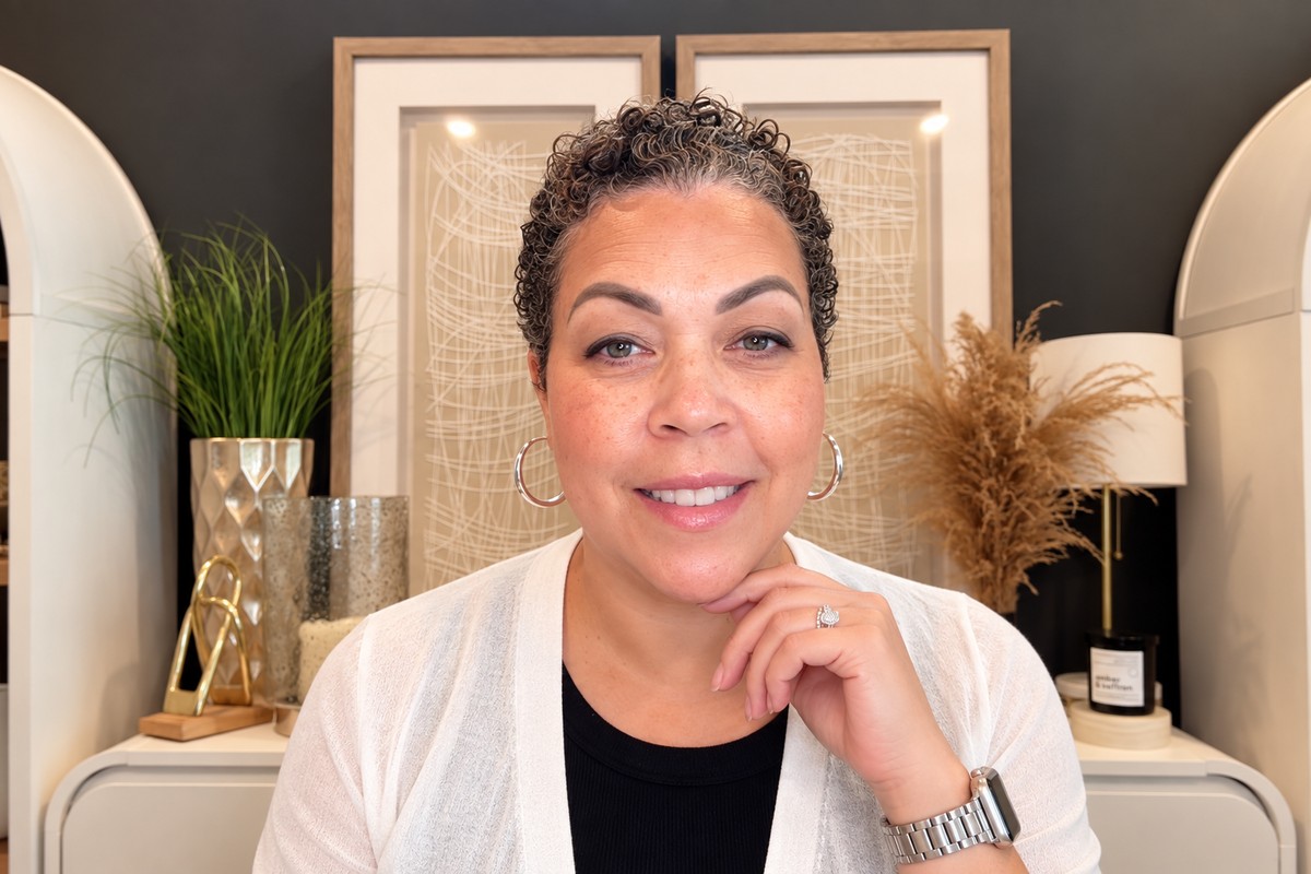 Nicole Wright smiling in a warm, styled interior